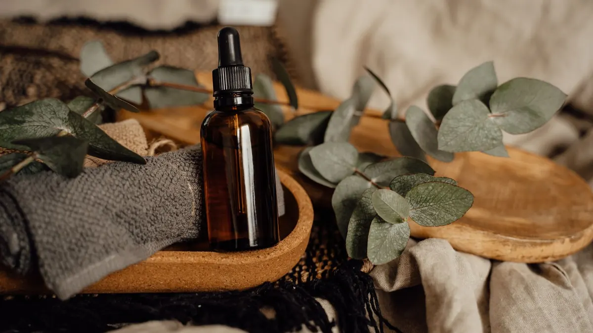 Amber dropper bottle of eucalyptus oil with eucalyptus leaves